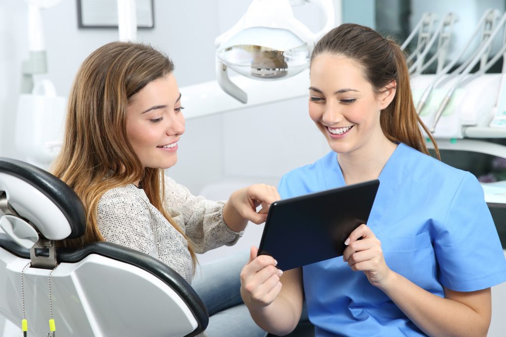 dentist showing patient a chart during consultation
