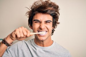 man brushing his teeth